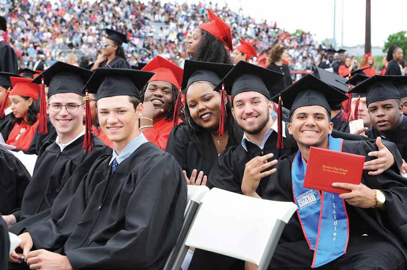 Young graduates of Brockton High School sitting at graduation.